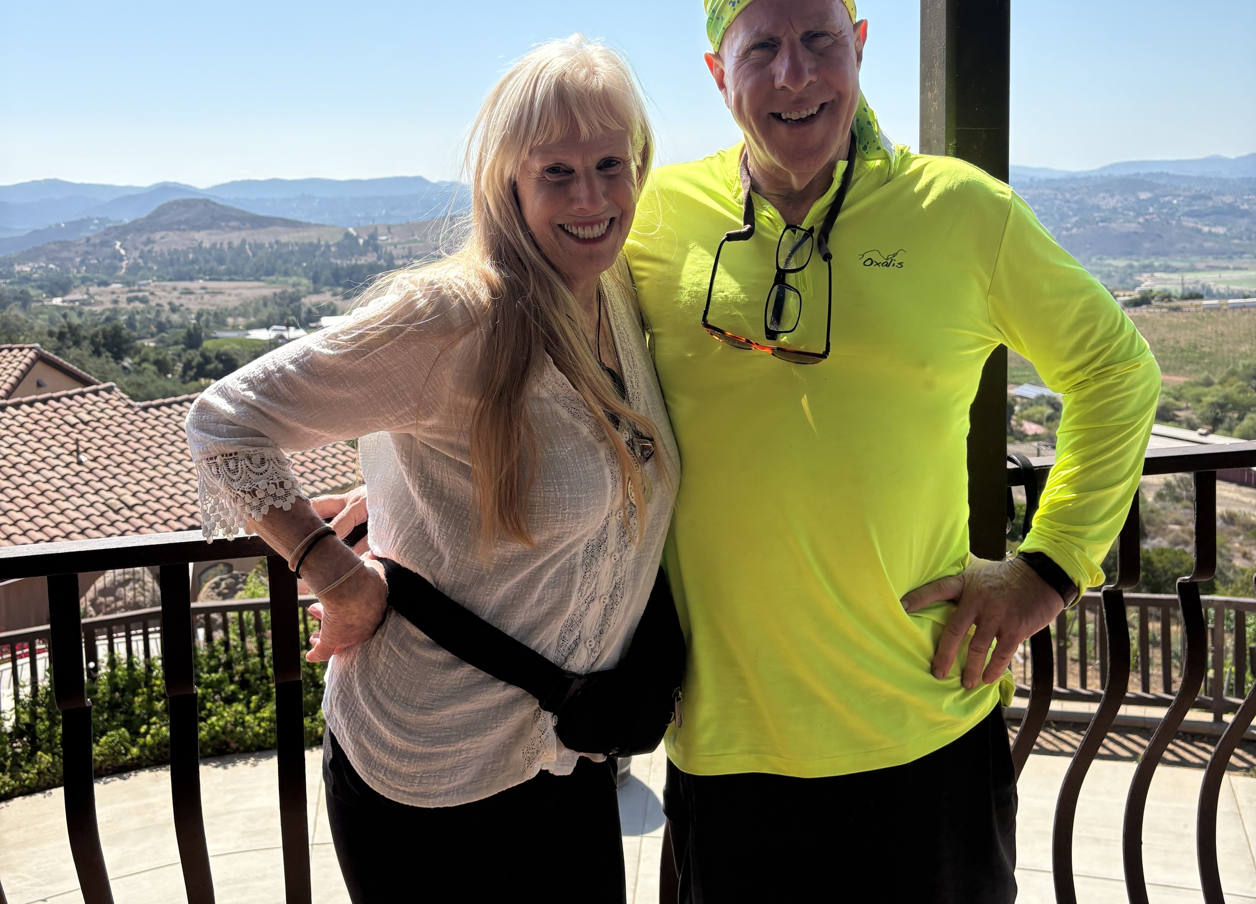 Taye and Daniel celebrating together, arm raised, overlooking the hills